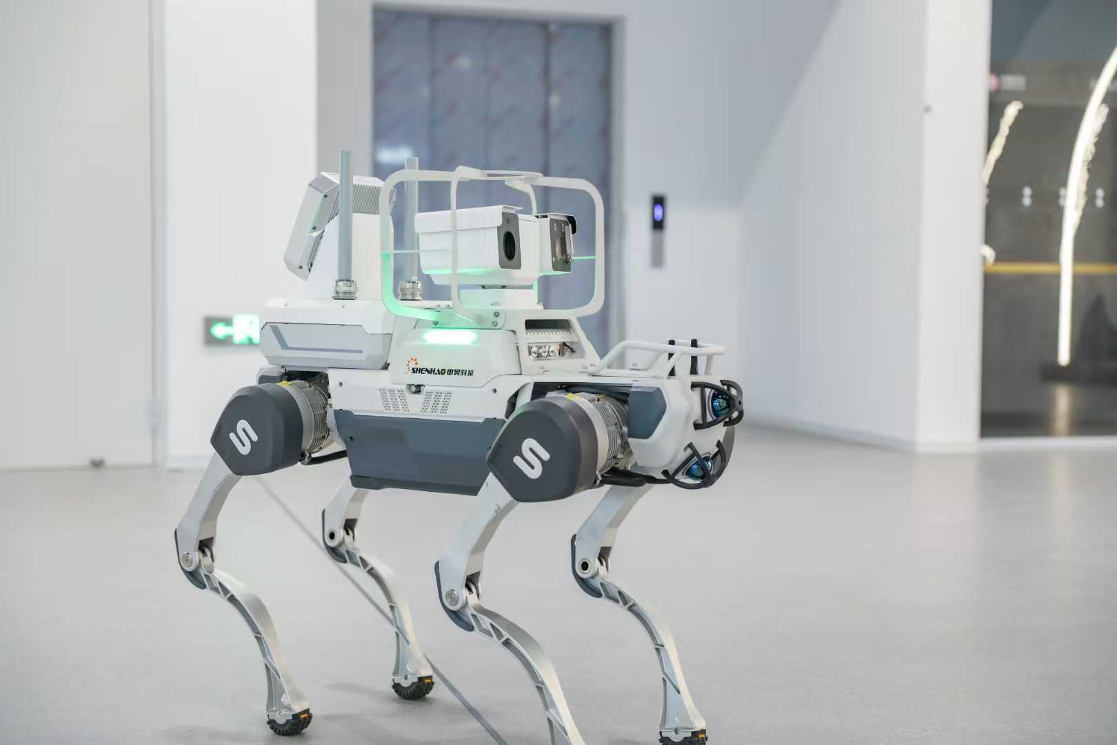A ShenHao quadruped inspection robot with a camera payload, shown in the company's exhibition hall in Hangzhou