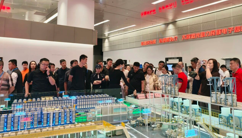 A business delegation viewing an automation line model in the Han's Laser exhibition hall