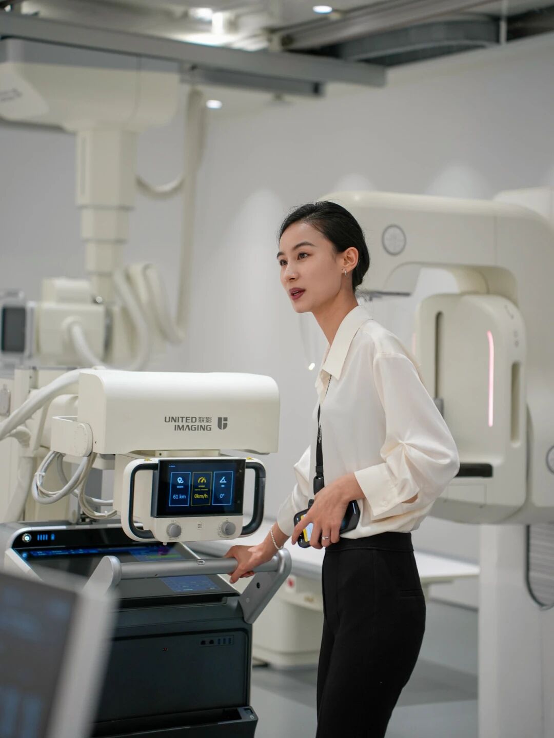 A guide presenting a mobile digital imaging unit in the United Imaging exhibition hall in Shanghai