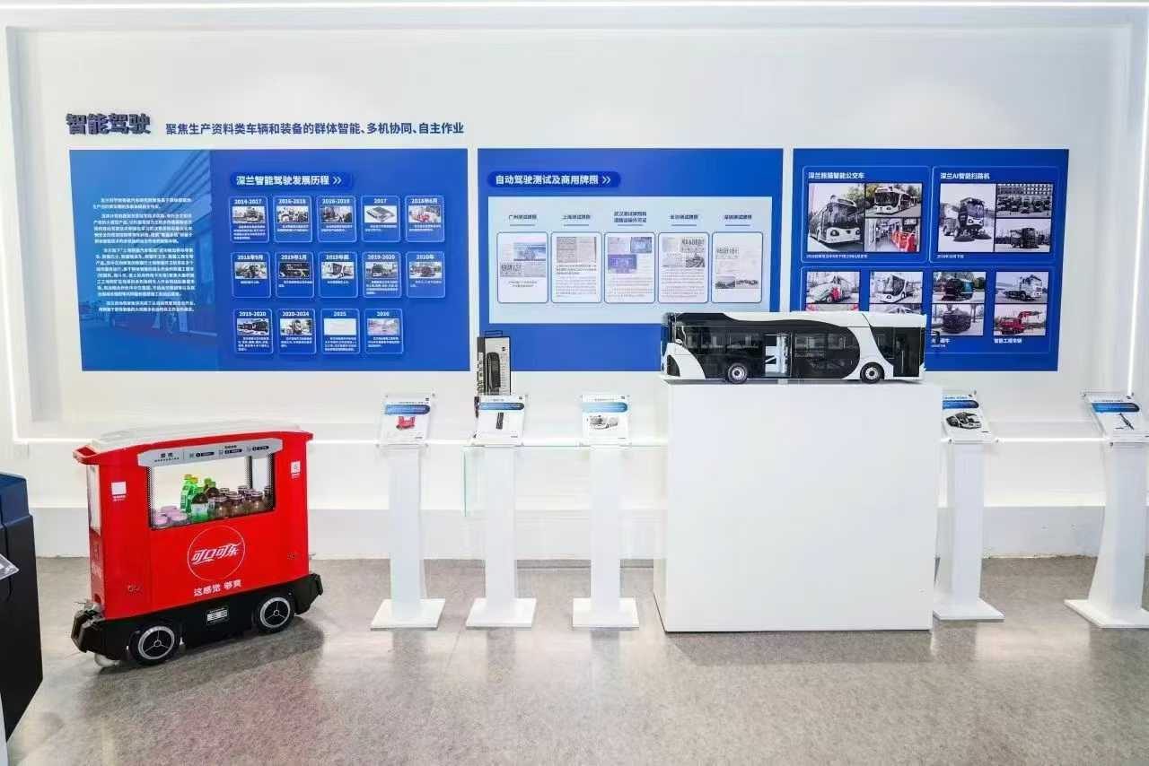 The intelligent driving display area, with the Panda smart bus model, the development timeline and demonstration vehicles including a mobile retail cart