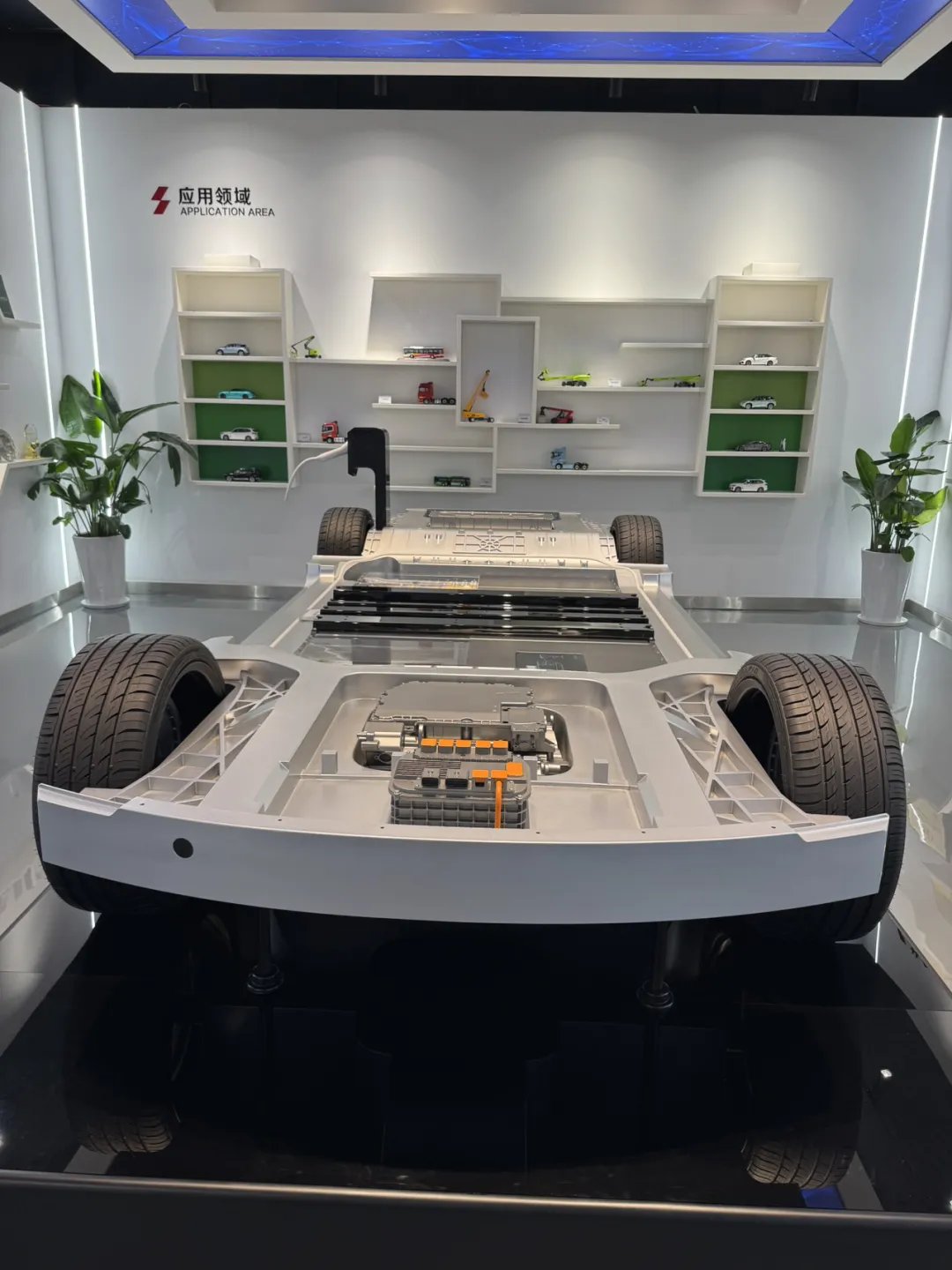 An electric-vehicle chassis with integrated battery pack on display in the EVE application area in Huizhou