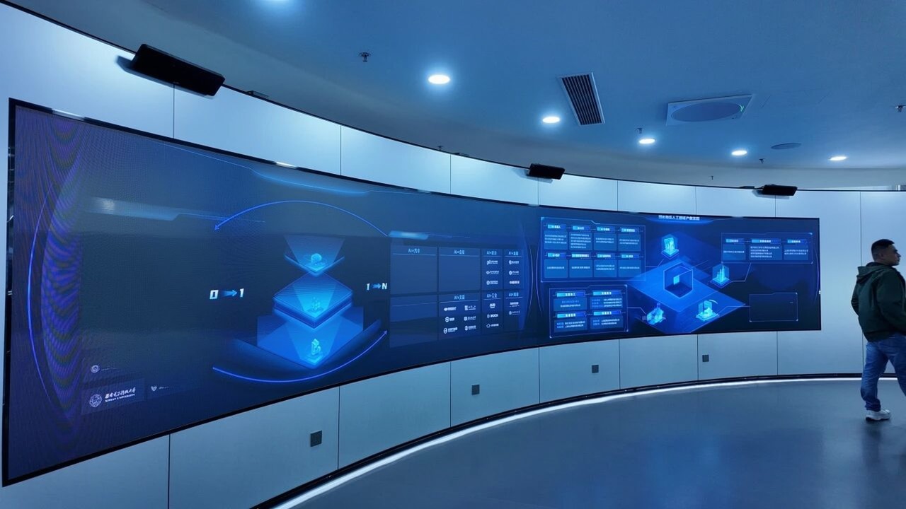 A curved display in the AISpeech exhibition hall showing the company's AI research programme and its university and regional cooperation network