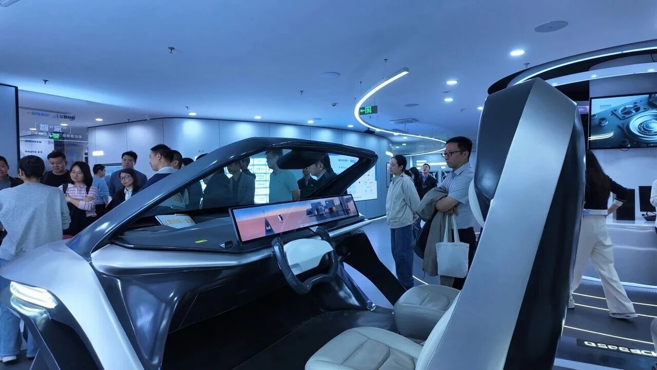 A visiting delegation around the smart cockpit demonstration vehicle in the AISpeech exhibition hall