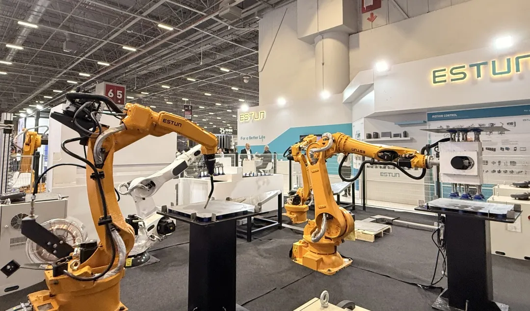 Estun welding robots demonstrating arc welding at an industrial exhibition stand