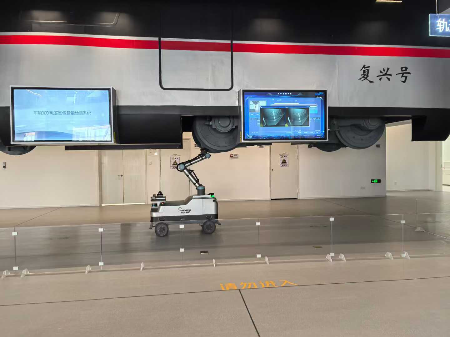 A rail vehicle-bottom dynamic image inspection robot demonstrated under a high-speed train mock-up in the exhibition hall