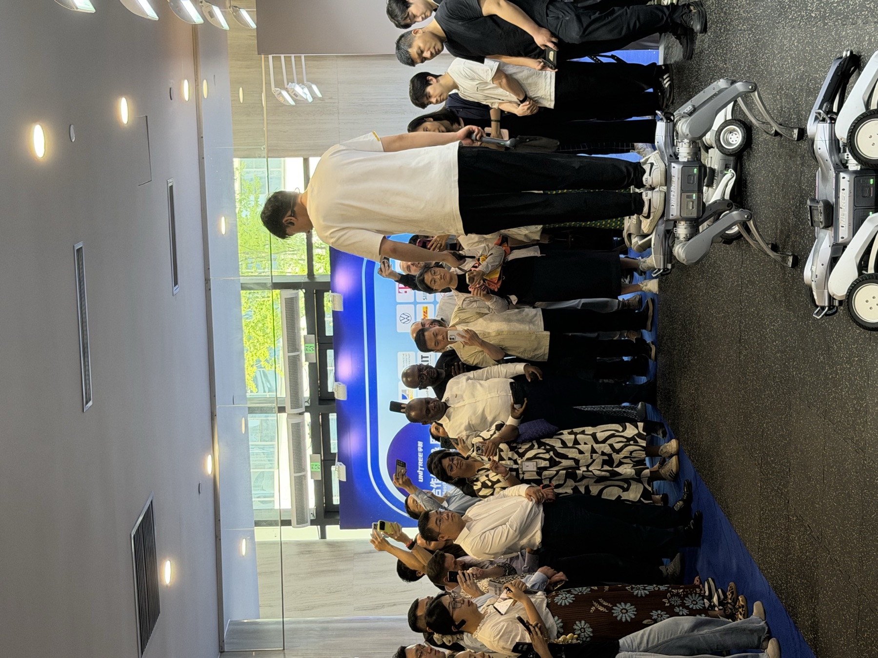 Visitors gather around a Unitree robot during the showroom tour