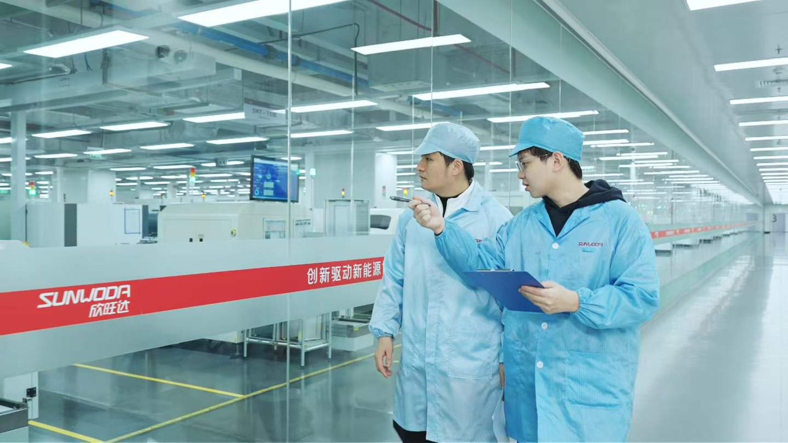 Inside a Sunwoda smart-manufacturing plant — automated equipment, conveyors and production systems viewed during a delegation visit